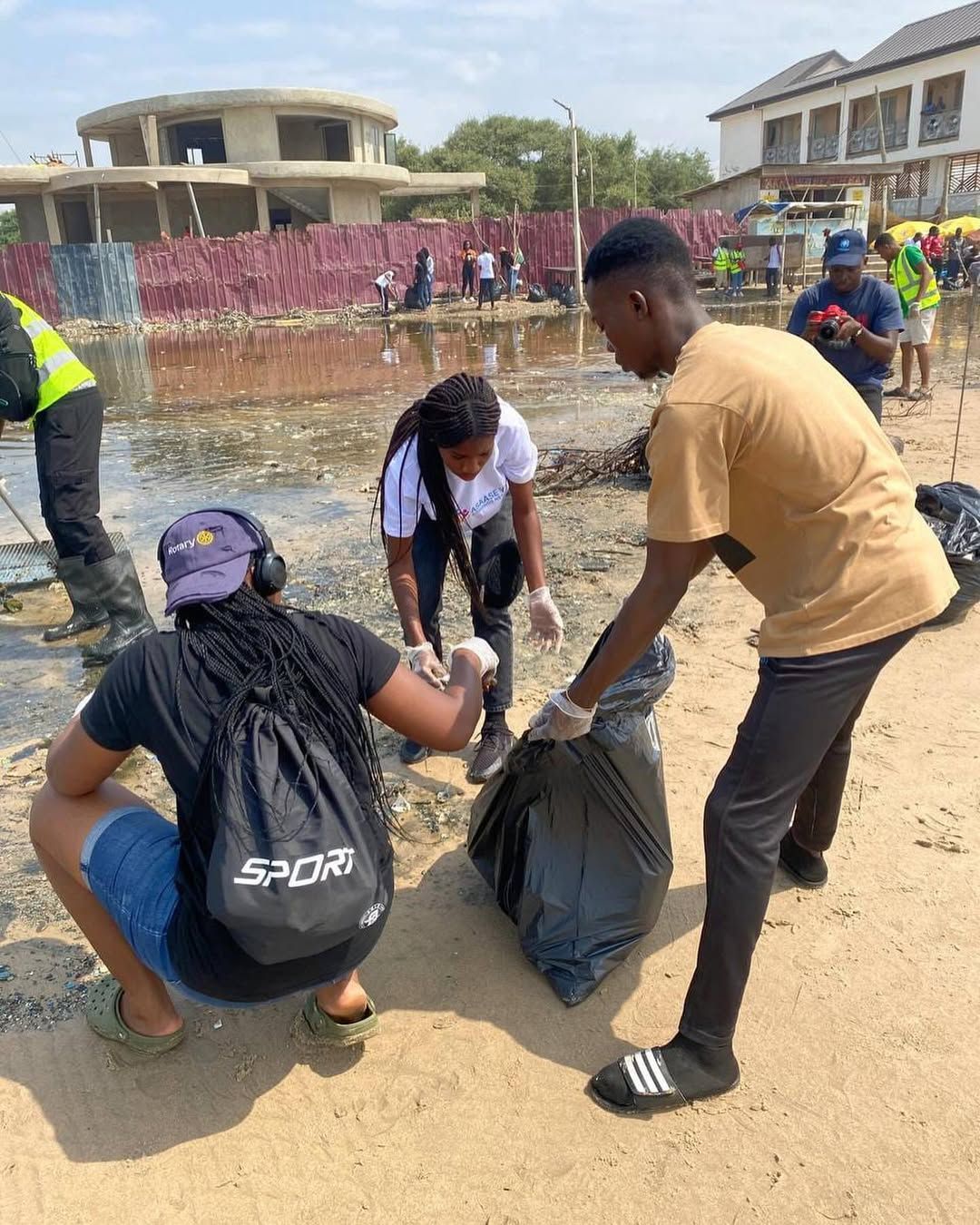 Volunteers bagging collected waste on the beach