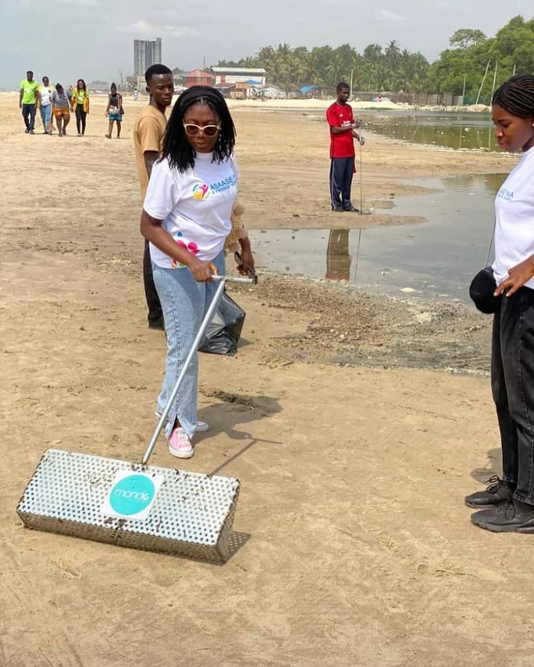Volunteer raking litter along the waterfront