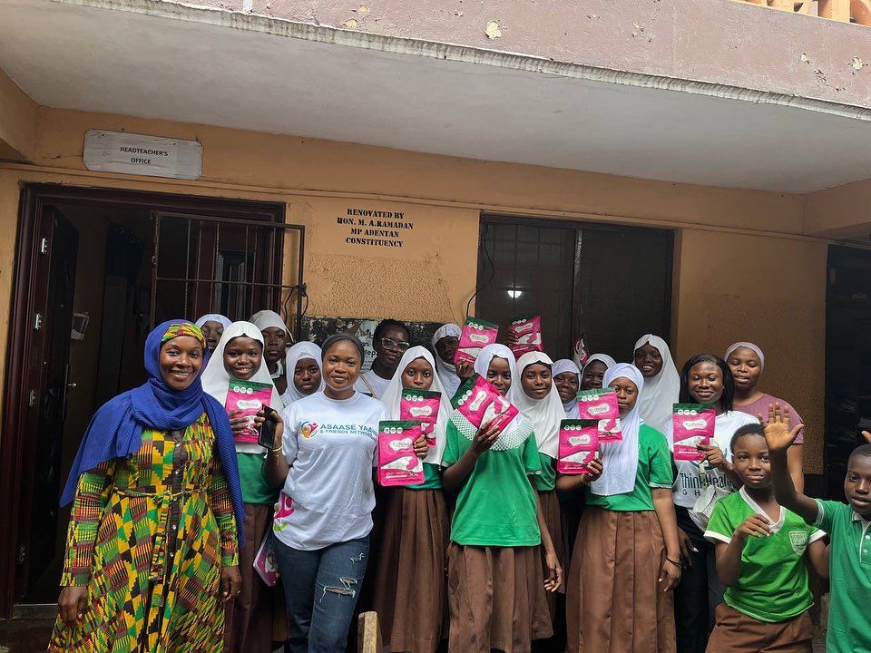 Schoolgirls and staff with donated sanitary pads
