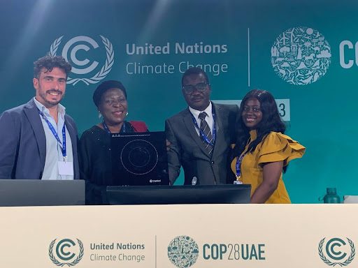 Asaase Yaa representatives with partners and a clean cookstove at COP28, the UN Climate Change Conference in the UAE